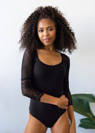 A dancer wearing a black leotard